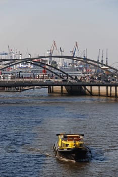 yellow tugboat in the port of Hamburg