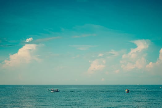 Sea sky cumulus cloud landscape view background. Calm water alone fishing boat. Destination aim progress concept.