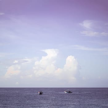 Sea sky cumulus cloud landscape view background. Calm water alone fishing boat. Destination aim progress concept.