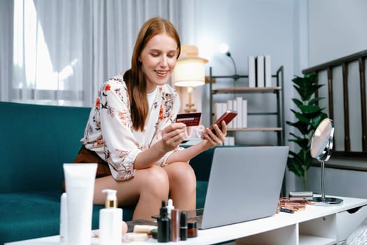 Young happy woman buy product by online shopping at home while ordering items from the internet with credit card online payment system protected by utmost cyber security from online store platform