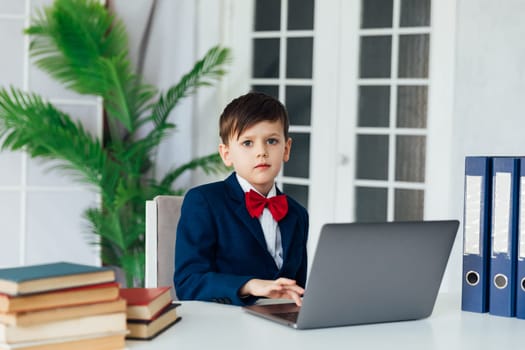 a student works in classroom office in an educational institution behind a laptop in the office