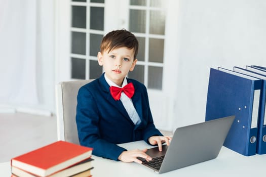 student sitting in the classroom at laptop with books in the office education online programming