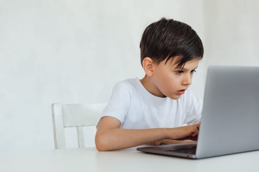 education online online games classes boy sitting at laptop at school