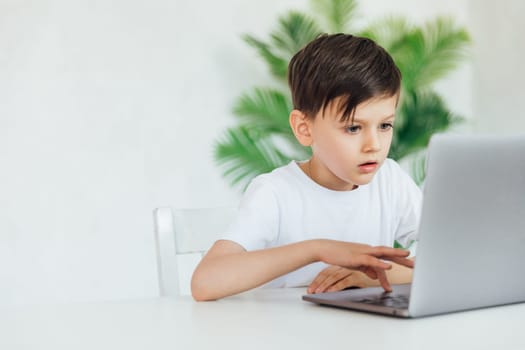 education online online games classes boy sitting at laptop at school