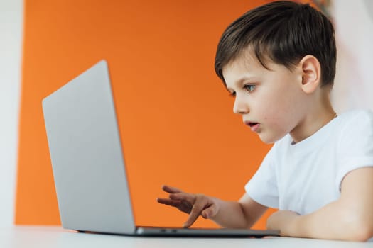 an education online online games boy sits at the computer in the office