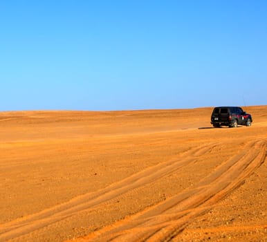 Jeep driving through a desert landscape,Sahara desert