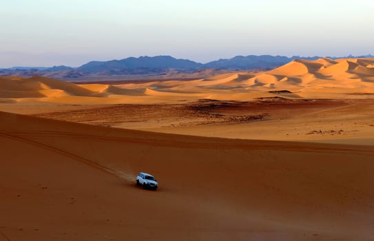Jeep driving in the sand dunes of the Sahara