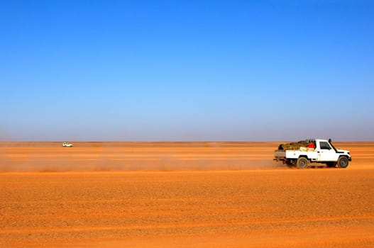 Jeep driving through a desert landscape,Sahara desert