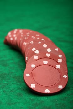 Gambling chips over green felt
