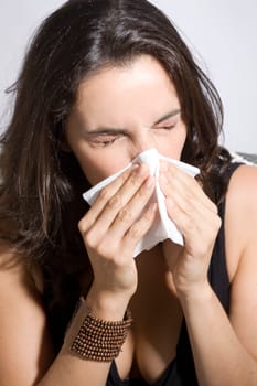 Woman sneezes