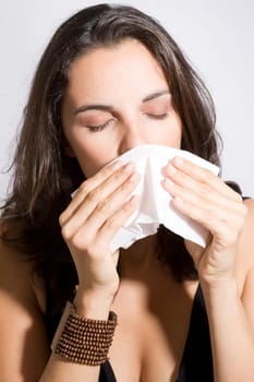 Woman sneezes