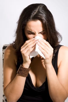Woman sneezes
