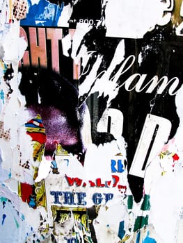 Torn up posters and garbage on a wall