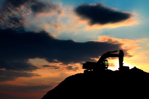 skyline excavator with colored sunset