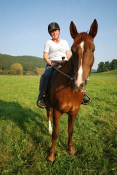 Woman with riding pony mare