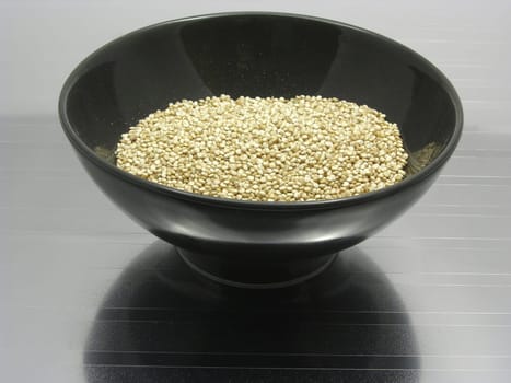 Porcelain bowl with quinoa on a reflective base