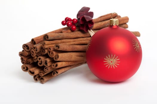 Cinnamon stick with red Christmas ornament