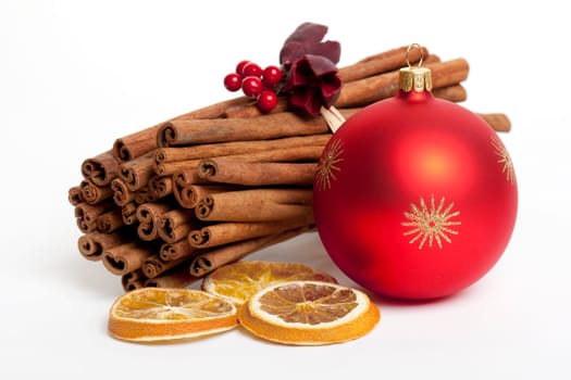 Cinnamon stick with red Christmas ornament