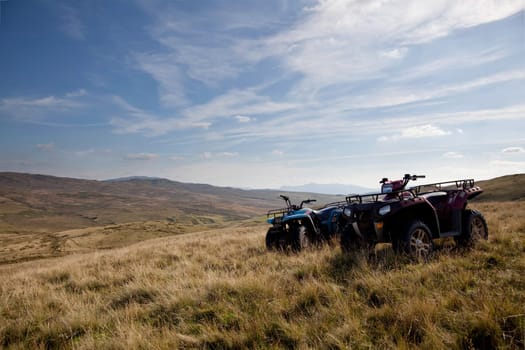 Pair of ATV quad bikes on lonely mountain