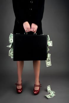 Woman holding briefcase with money