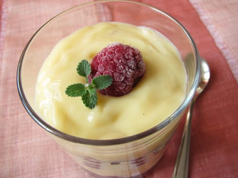 Vanilla pudding with wild berries in a glass