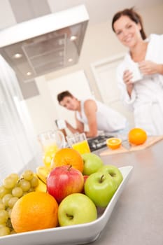 Happy couple having breakfast in the kitchen