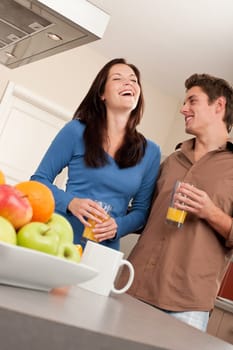Happy couple drinking orange juice