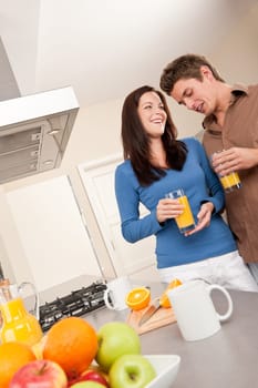 Happy couple drinking orange juice