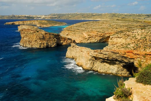 Rocky cliffs in front of Comino