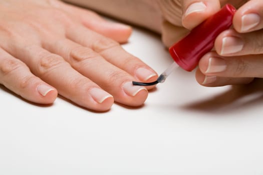 Young woman doing manicure