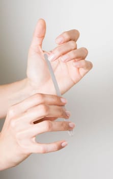 Young woman doing manicure