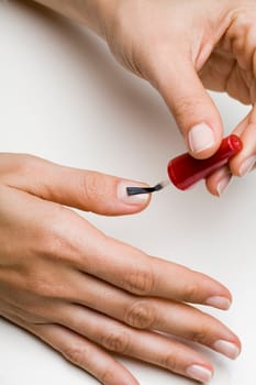 Young woman doing manicure