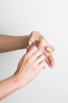 Young woman doing manicure