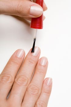 Young woman doing manicure