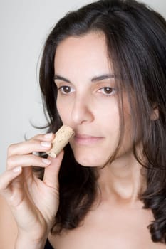 Pretty woman smells on a wine cork