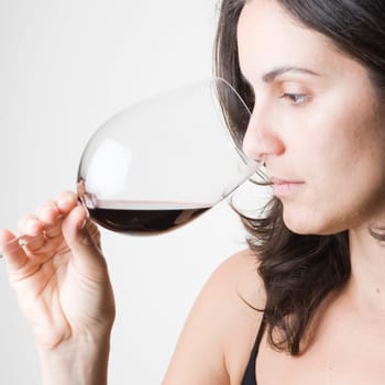 Young woman tasting red wine