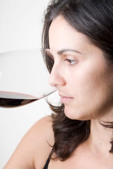 Pretty woman smells a wine glass