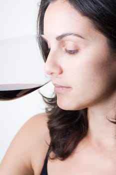 Young woman tasting red wine