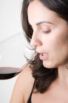 Young woman tasting red wine