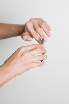 Young woman doing manicure