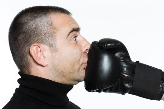 studio shot portrait on isolated white background of a Funny man punched by a boxing glove