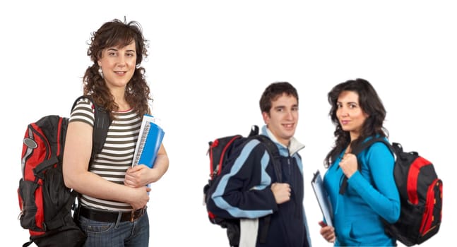 Three students with books and backpacks