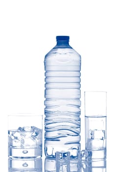 Bottle and glasses of mineral water with ice cubes