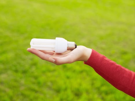 Woman holding light bulbs. Selective focus, copy space