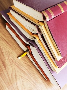 pile of books and pencil on desk. Copy space
