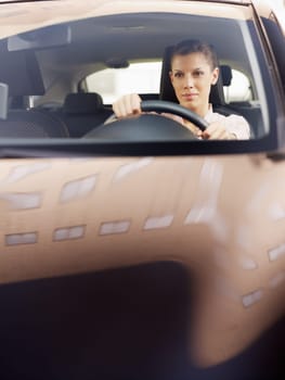 woman driving car. Reflections of building on hood. Copy space