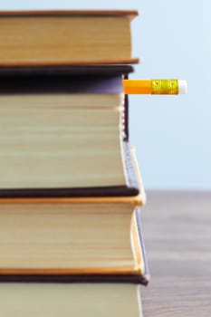 pile of books and pencil on desk. Selective focus