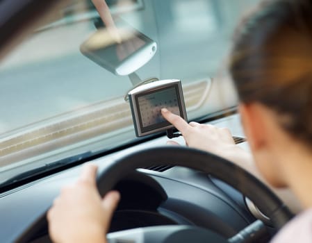 Rear view of woman typing on gps. Selective focus