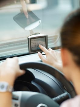Rear view of woman typing on gps. Selective focus