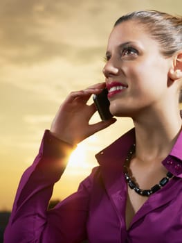 business woman talking on mobile phone outdoors
